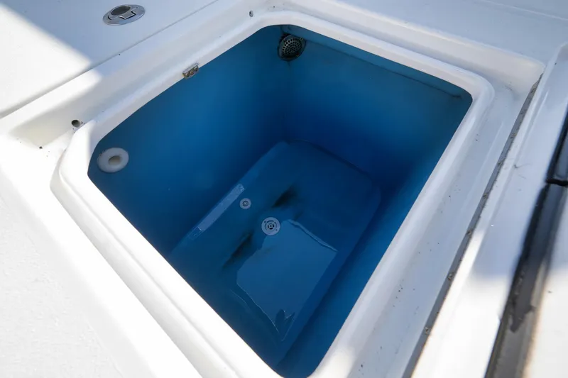 Slide: The Image of Livewell compartment on a 2021 Contender 39 ST boat, featuring a blue interior. - 24