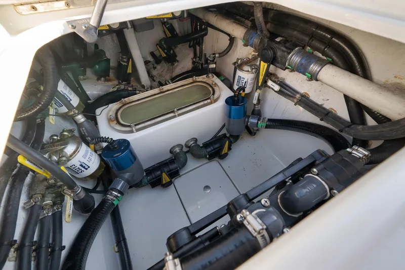 Slide: The Image of Engine compartment of 2021 Contender 39 ST boat, showcasing complex wiring and components. - 26