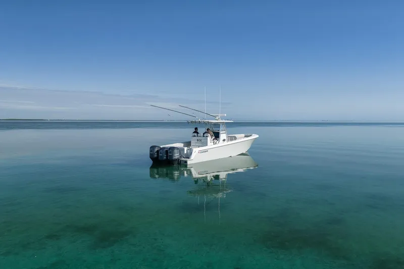 Slide: The Image of 2021 Contender 39 ST boat on calm, clear water under a blue sky. - 3