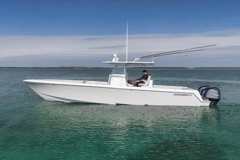 Slide: The Image of 2021 Contender 39 ST boat on clear water with dual Yamaha engines. - 4