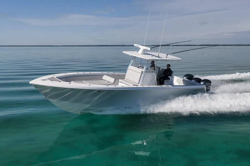 Slide: The Image of 2021 Contender 39 ST boat cruising on clear, calm waters under a blue sky. - 6