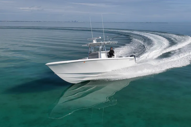 Slide: The Image of 2021 Contender 39 ST boat cruising on clear, calm waters. - 7