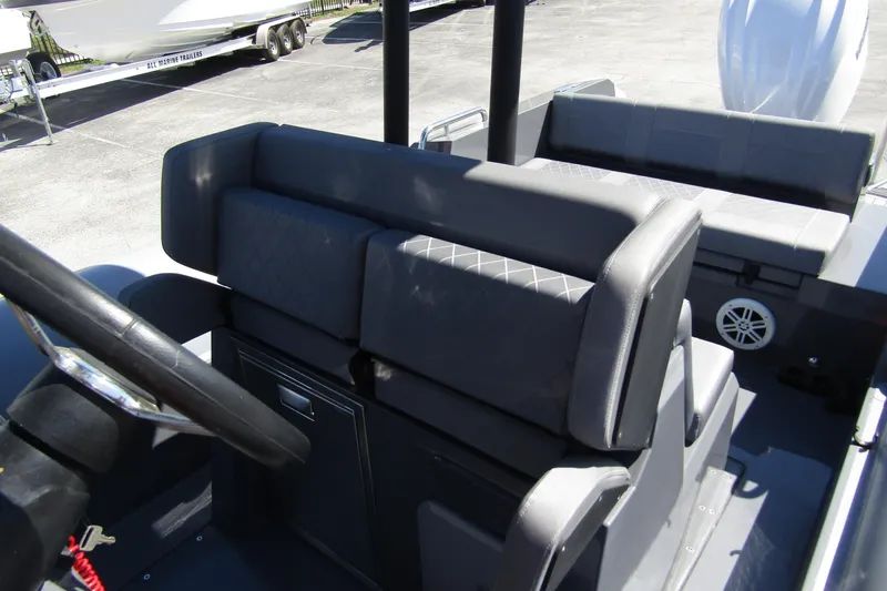 Slide: The Image of 2024 Northstar Orion 8 boat interior with gray seating and steering wheel. - 16