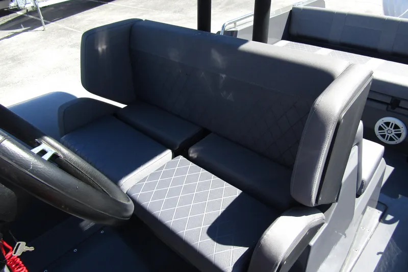 Slide: The Image of 2024 Northstar Orion 8 boat interior with cushioned seating and steering wheel. - 17