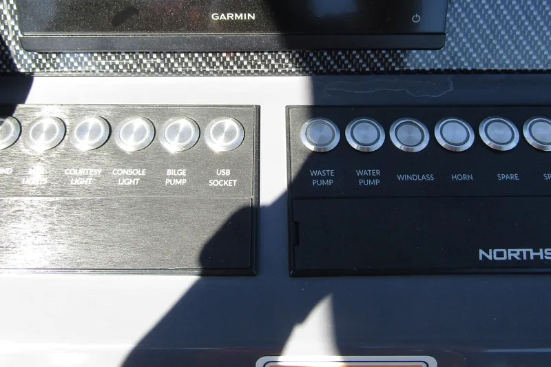 Slide: The Image of Control panel of 2024 Northstar Orion 8 boat with labeled buttons and Garmin display. - 21