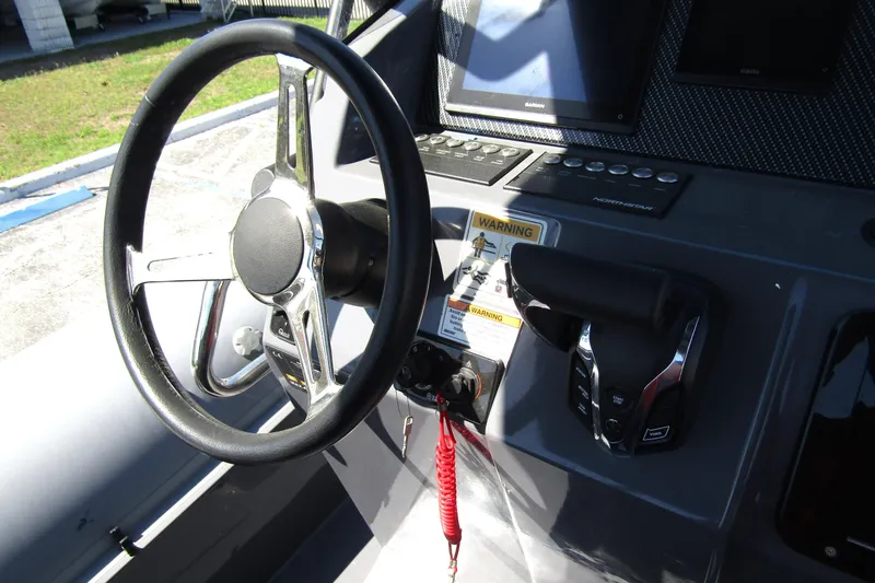 Slide: The Image of 2024 Northstar Orion 8 boat dashboard with steering wheel and control panel. - 23