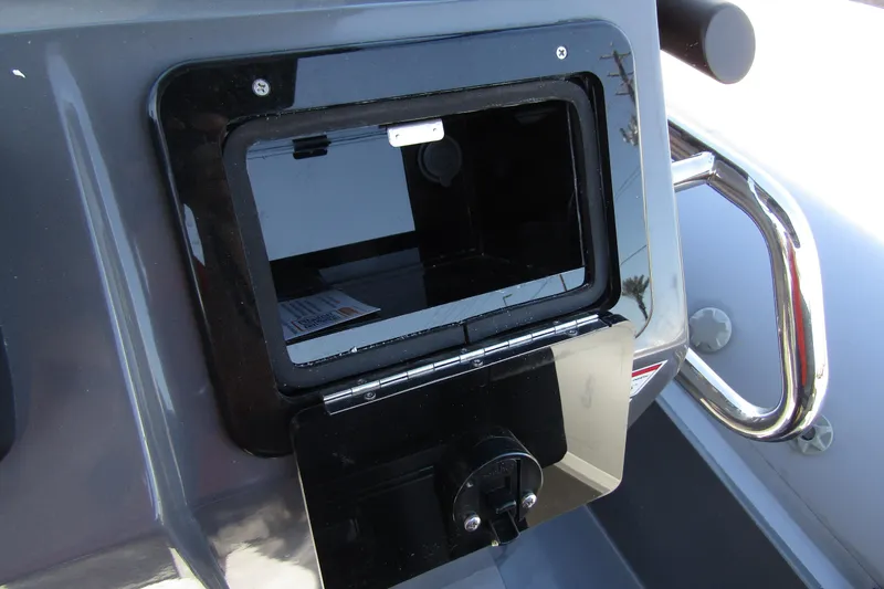 Slide: The Image of 2024 Northstar Orion 8 boat compartment with open storage and chrome handle. - 24