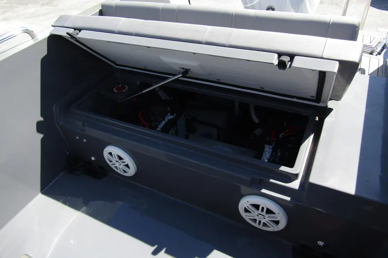 Slide: The Image of Open storage compartment in 2024 Northstar Orion 8 boat, featuring speakers and visible battery. - 26