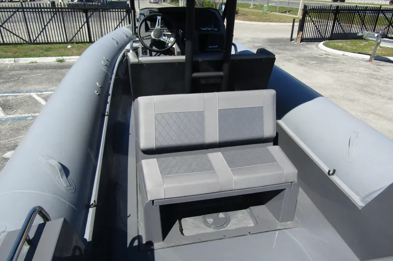 Slide: The Image of 2024 Northstar Orion 8 boat interior with gray seating and steering console. - 27