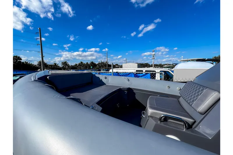 Slide: The Image of 2024 Northstar Orion 8 boat interior with gray cushioned seating and textured flooring. - 9