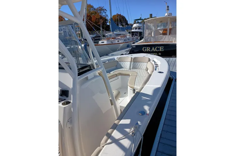 Slide: The Image of 2021 Sea Fox 228 Commander boat docked, featuring spacious seating and sleek design. - 10