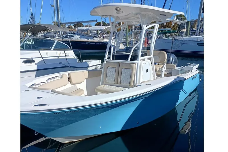 Slide: The Image of 2021 Sea Fox 228 Commander boat in harbor, blue and white design. - 2