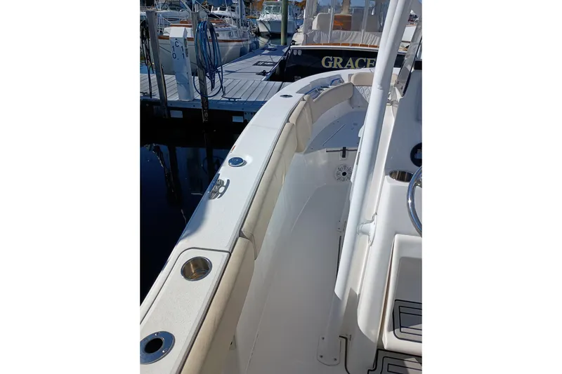 Slide: The Image of 2021 Sea Fox 228 Commander boat docked, showcasing sleek interior and seating. - 7