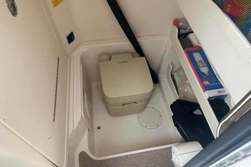 Slide: The Image of 2023 Grady-White Fisherman 257 interior storage with portable toilet and safety equipment. - 12