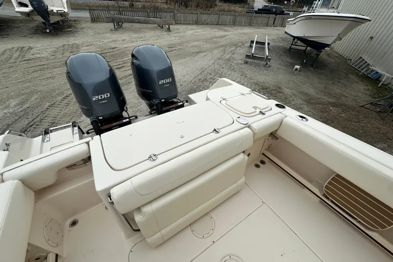 Slide: The Image of 2023 Grady-White Fisherman 257 boat with dual Yamaha 200 engines, docked on land. - 17