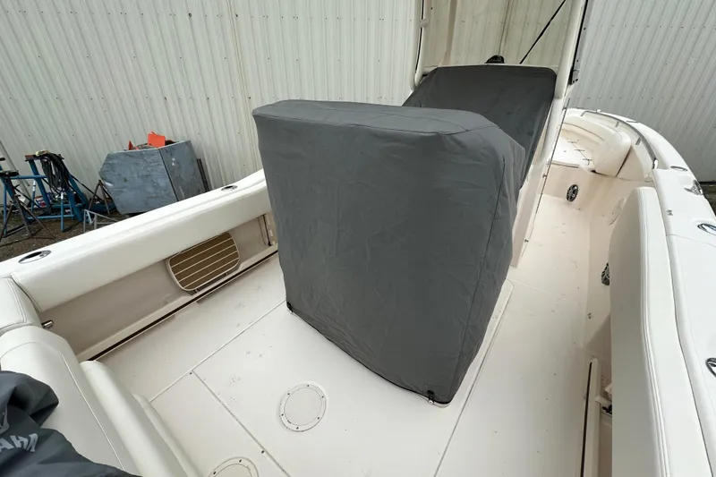 Slide: The Image of 2023 Grady-White Fisherman 257 boat interior with covered console, white seating, and storage compartments. - 19
