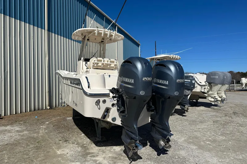 Slide: The Image of 2023 Grady-White Fisherman 257 boat with dual Yamaha 200 engines, parked outdoors. - 2