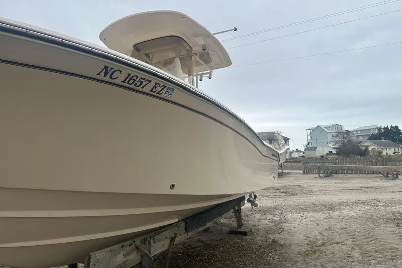 Slide: The Image of 2023 Grady-White Fisherman 257 boat on a trailer, side view, overcast sky. - 6