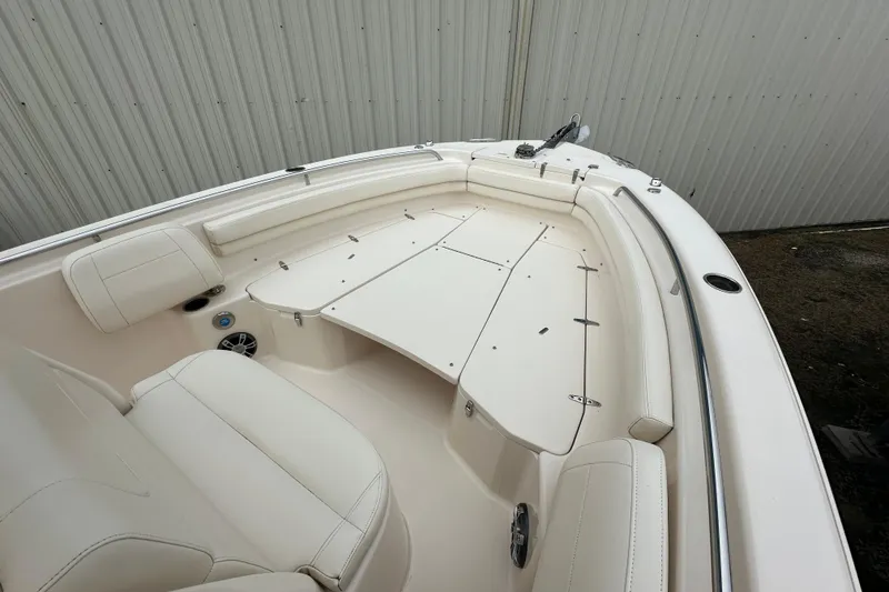 Slide: The Image of 2023 Grady-White Fisherman 257 boat interior with cushioned seating and storage compartments. - 7