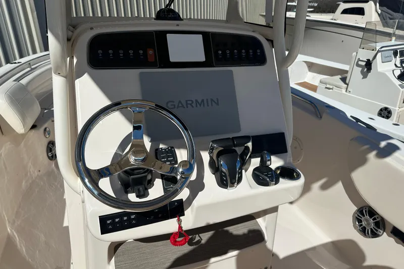 Slide: The Image of 2023 Grady-White Fisherman 257 boat console with Garmin navigation system and steering wheel. - 9