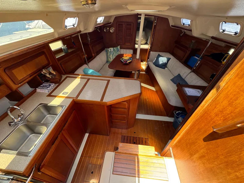 Slide: The Image of Interior of 1992 Hunter Legend 375 sailboat with wood finish and cozy seating area. - 14