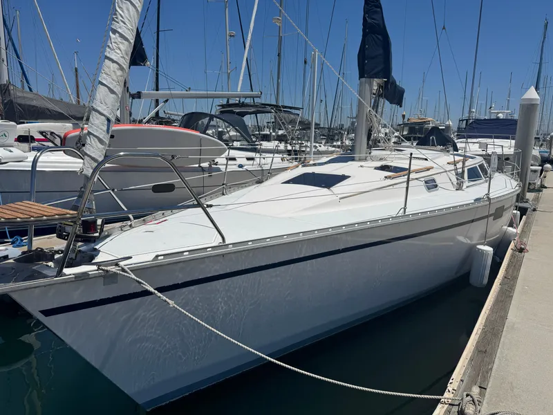 Slide: The Image of Hunter Legend 375 sailboat, 1992 model, docked at marina under clear blue sky. - 2