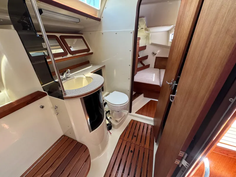 Slide: The Image of 1992 Hunter Legend 375 yacht interior with bathroom and cabin, featuring wood accents and modern amenities. - 21