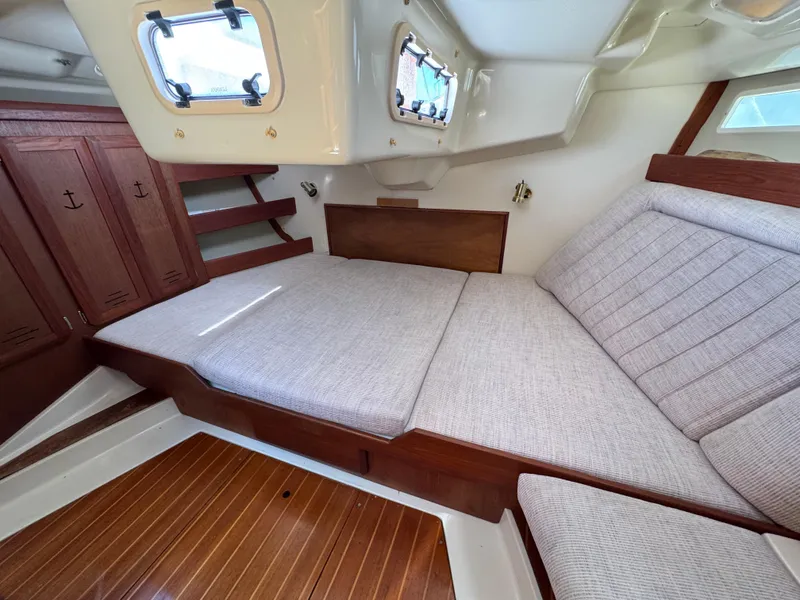 Slide: The Image of Interior cabin of 1992 Hunter Legend 375 sailboat with wooden accents and cushioned seating. - 24