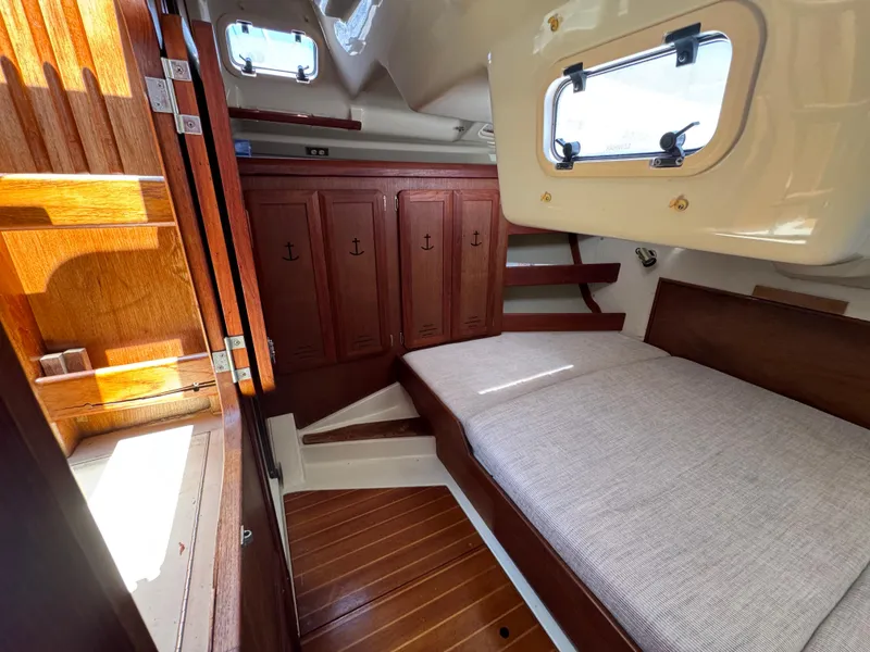 Slide: The Image of Interior of 1992 Hunter Legend 375 sailboat with wooden cabinetry and cozy sleeping area. - 25