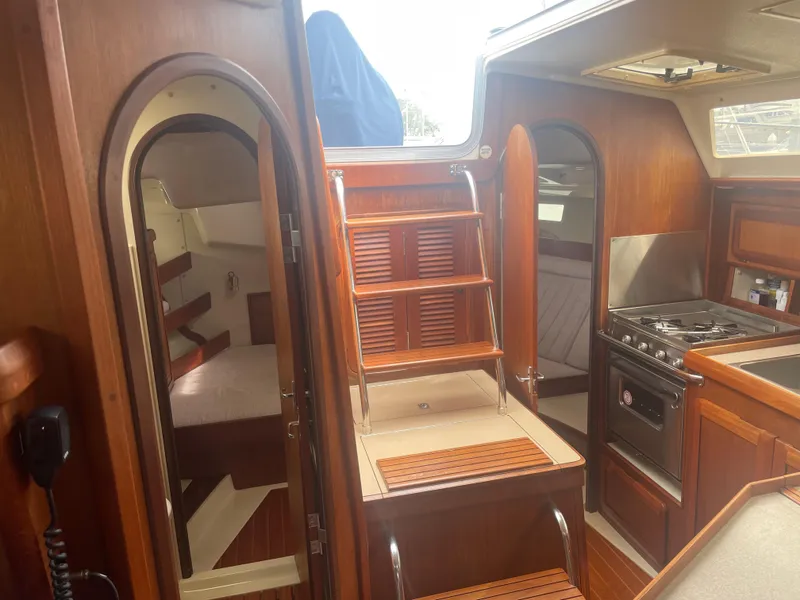 Slide: The Image of Interior of 1992 Hunter Legend 375 sailboat with wood finish and compact kitchen. - 4