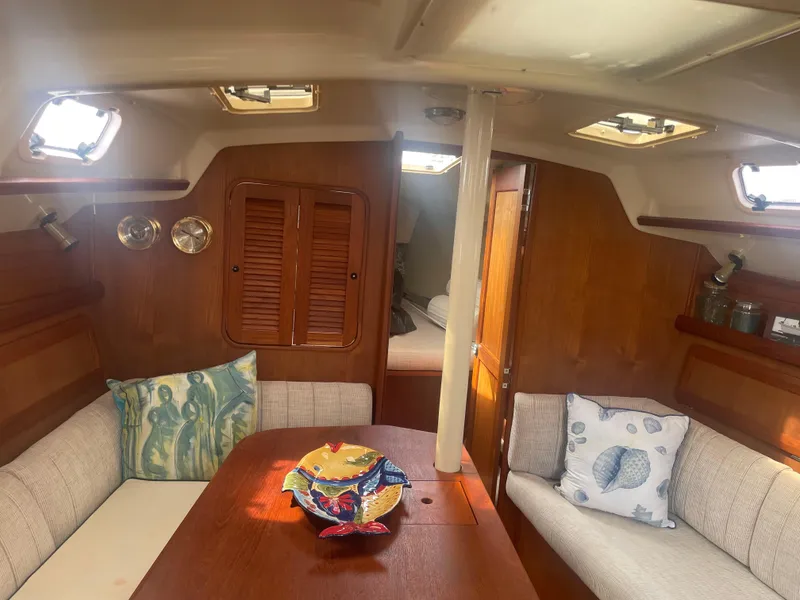 Slide: The Image of Interior of 1992 Hunter Legend 375 sailboat with cozy seating and decorative pillows. - 5
