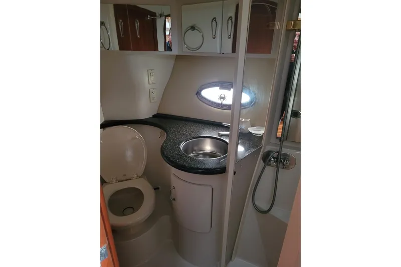 Slide: The Image of 2004 Carver 444 Cockpit Motor Yacht bathroom with sink, toilet, and shower. - 10