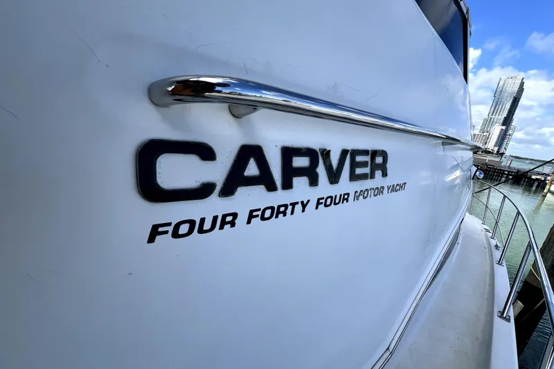 Slide: The Image of 2004 Carver 444 Cockpit Motor Yacht docked with city skyline in background. - 3
