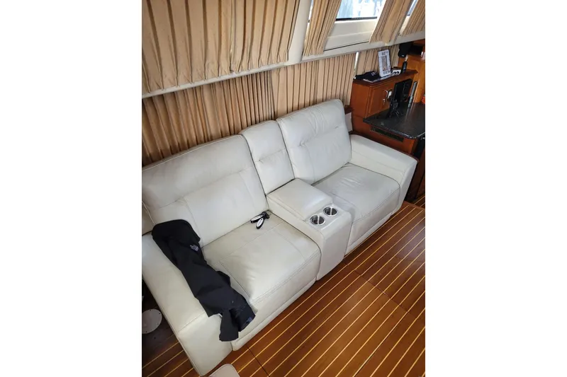 Slide: The Image of Luxurious interior of 2004 Carver 444 Cockpit Motor Yacht with leather seating and wood flooring. - 6