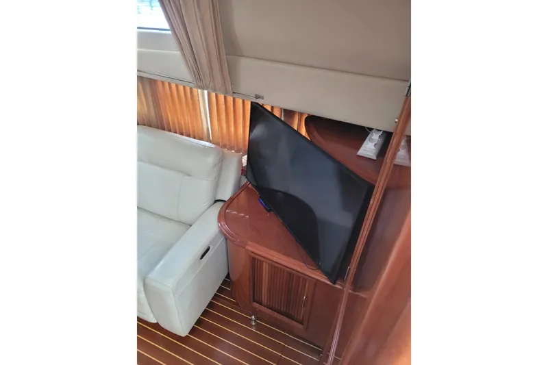 Slide: The Image of Interior of 2004 Carver 444 Cockpit Motor Yacht with TV and white sofa. - 7