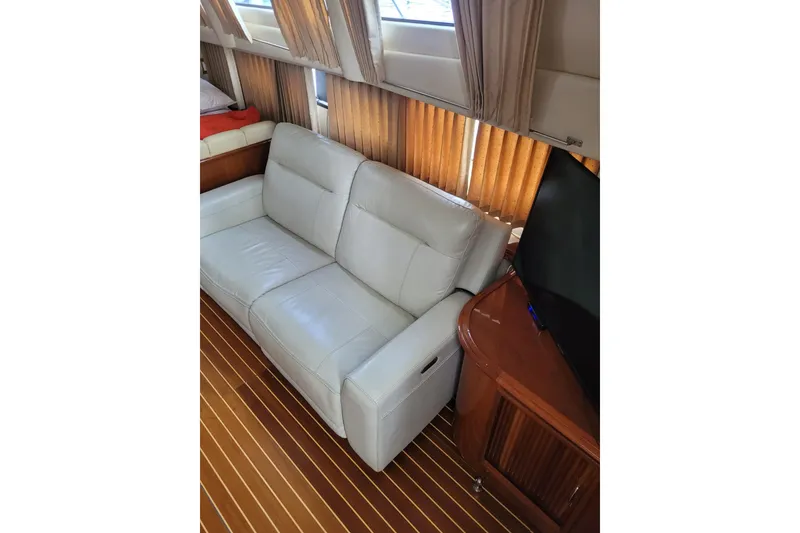 Slide: The Image of Luxurious interior of 2004 Carver 444 Cockpit Motor Yacht with leather sofa and wooden flooring. - 8