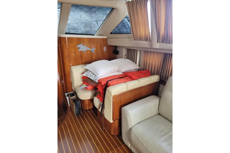 Slide: The Image of Interior of 2004 Carver 444 Cockpit Motor Yacht with cozy seating and wooden accents. - 9