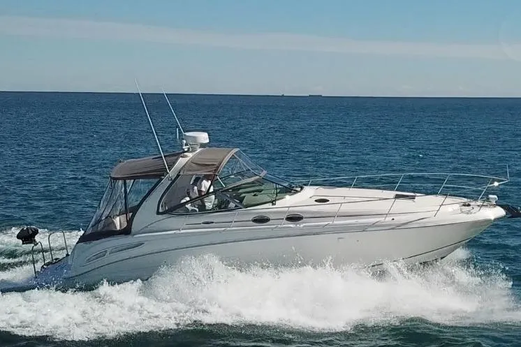 The Image of 2005 Sea Ray 360 Sundancer cruising on open water under clear skies. - 0