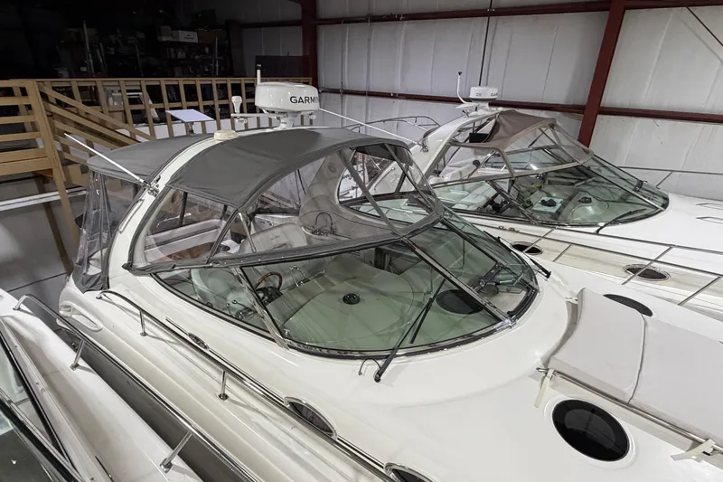 Slide: The Image of 2005 Sea Ray 360 Sundancer yacht in storage, featuring sleek design and covered cockpit. - 10