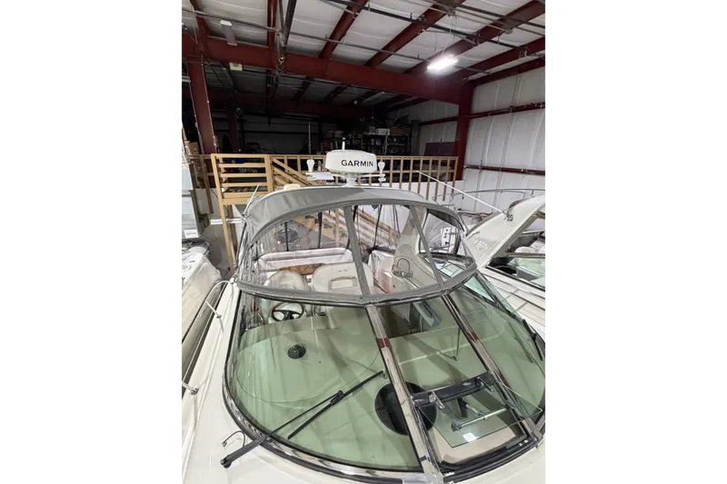 Slide: The Image of 2005 Sea Ray 360 Sundancer in storage, featuring Garmin equipment and sleek design. - 13