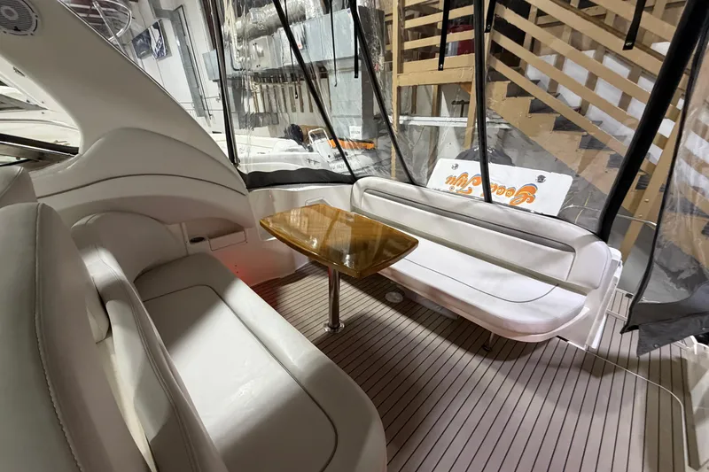 Slide: The Image of Interior of 2005 Sea Ray 360 Sundancer with seating and wooden table. - 14