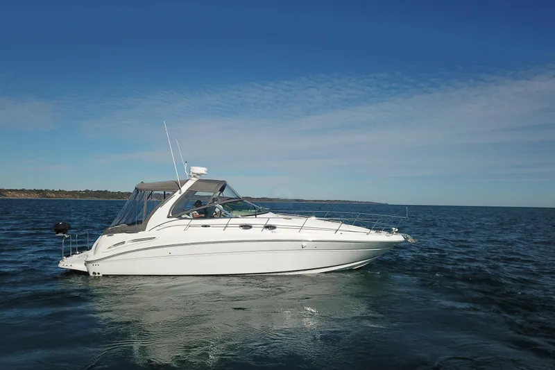 Slide: The Image of 2005 Sea Ray 360 Sundancer yacht cruising on open water under clear skies. - 2