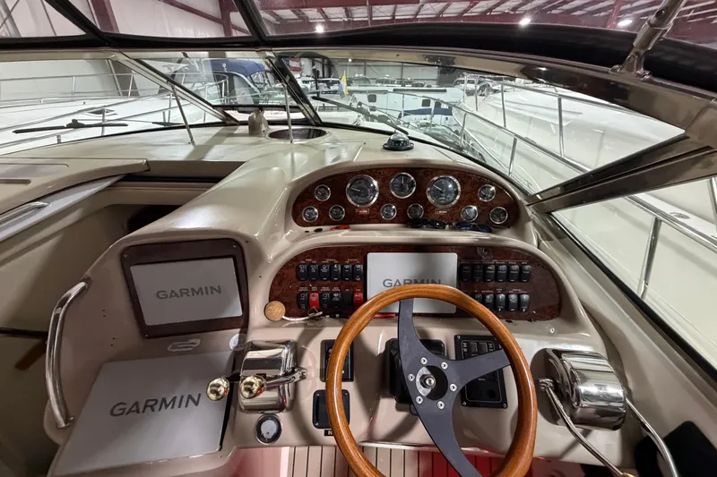 Slide: The Image of 2005 Sea Ray 360 Sundancer helm with Garmin navigation, wood accents, and steering wheel. - 22