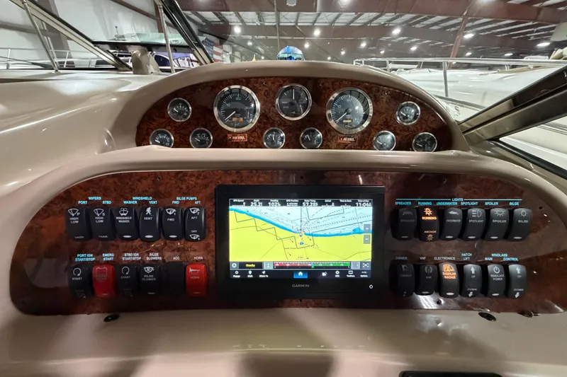 Slide: The Image of Dashboard of a 2005 Sea Ray 360 Sundancer with navigation and control panels. - 24