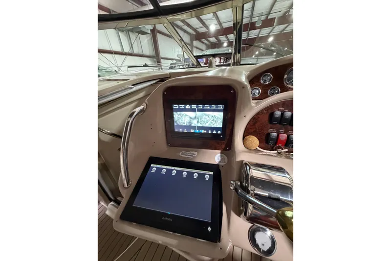 Slide: The Image of Helm of 2005 Sea Ray 360 Sundancer with navigation screens and controls. - 25