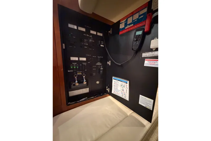Slide: The Image of Electrical panel of a 2005 Sea Ray 360 Sundancer boat with control switches and a radio. - 27