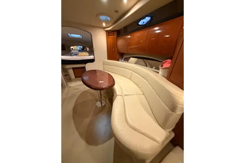 Slide: The Image of Luxurious interior of 2005 Sea Ray 360 Sundancer yacht with curved seating and wooden table. - 29