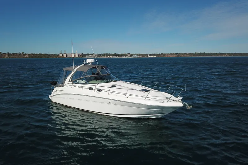 Slide: The Image of 2005 Sea Ray 360 Sundancer yacht cruising on open water under clear skies. - 3