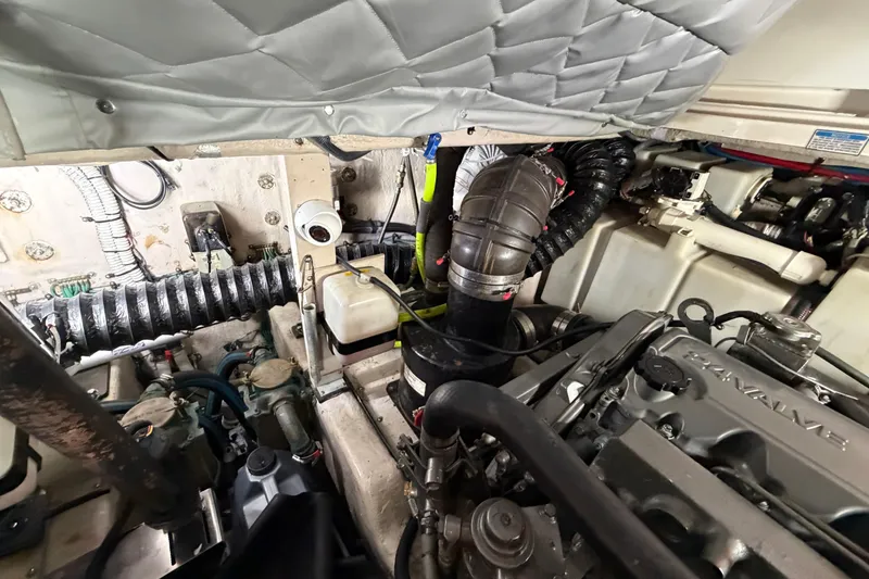 Slide: The Image of Engine compartment of 2005 Sea Ray 360 Sundancer, showcasing mechanical components and wiring. - 45