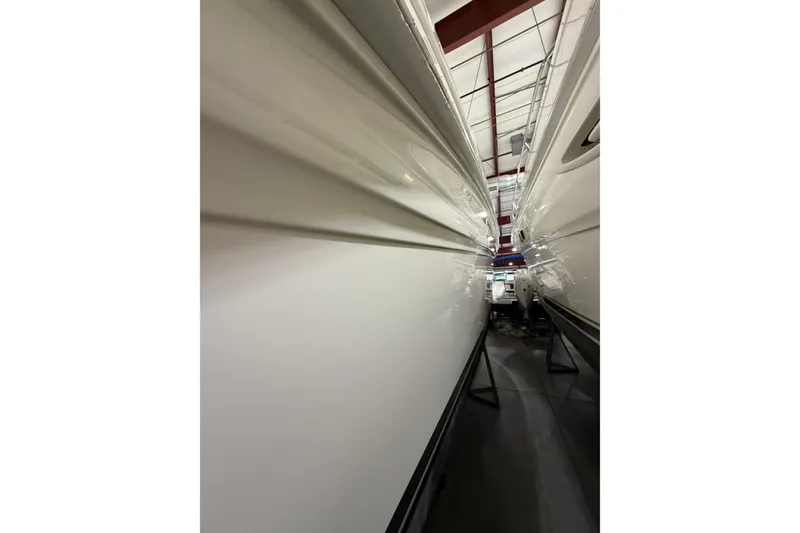 Slide: The Image of 2005 Sea Ray 360 Sundancer yacht in storage, showcasing sleek hull design. - 49